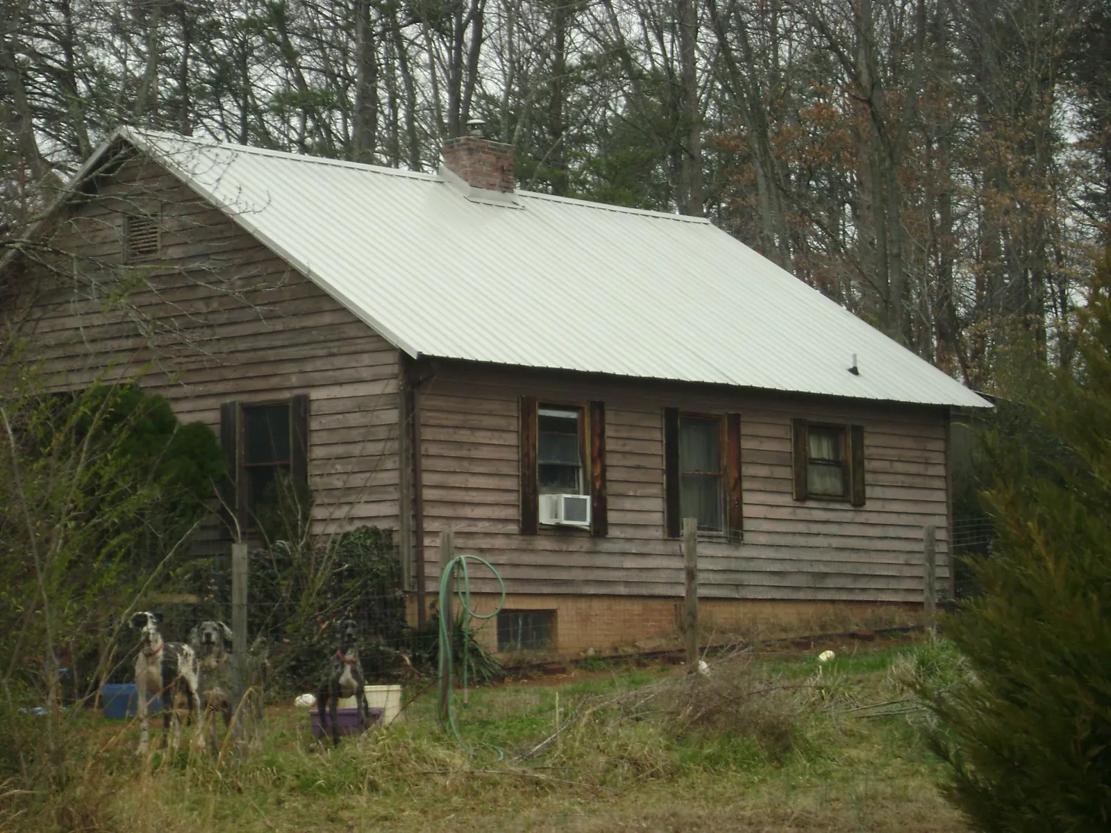 White metal roof on an old wood sided farmhouse, from a Asphalt Shingle Roof Repair job in Montpelier Station